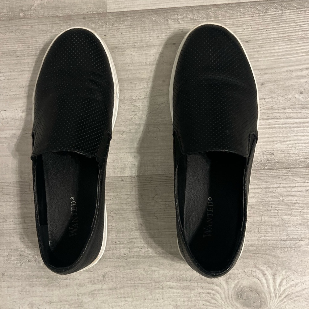 Comfortable black leather slip on sneaker with white sole